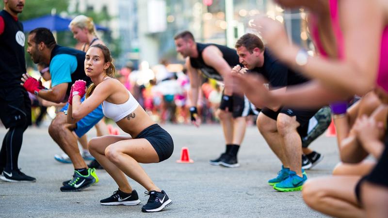People exercise outdoors at Herald Square Plaza at a free workout class in New York City.
