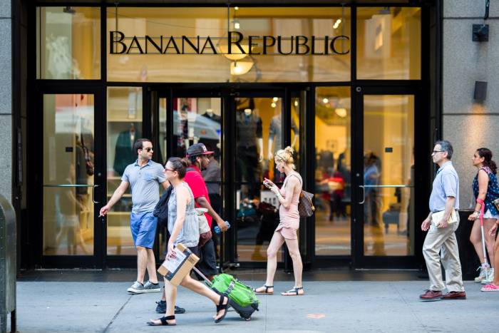 People walk past the front of Banana Republic on 34th Street NYC.