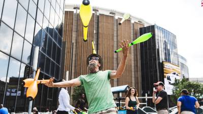 A man juggles in Midtown Manhattan