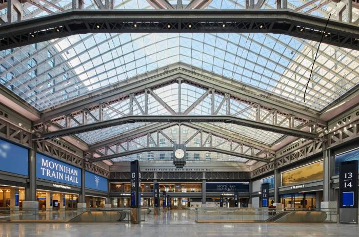 A grand interior view of Moynihan Train Hall, showing off the stations glass ceilings and airy interior.