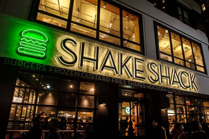 Illuminated Shake Shack sign at night