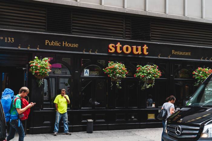 People walking past Stout NYC