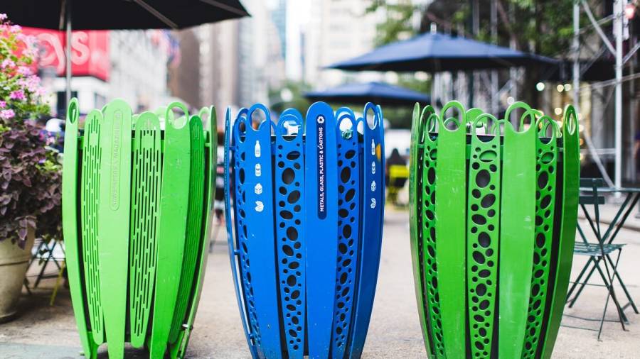 Recycling cans designed by the 34th Street Partnership sit in Herald Square Park in New York City.