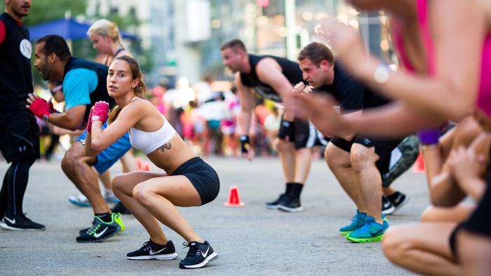 People exercise outdoors at Herald Square Plaza at a free workout class in New York City.