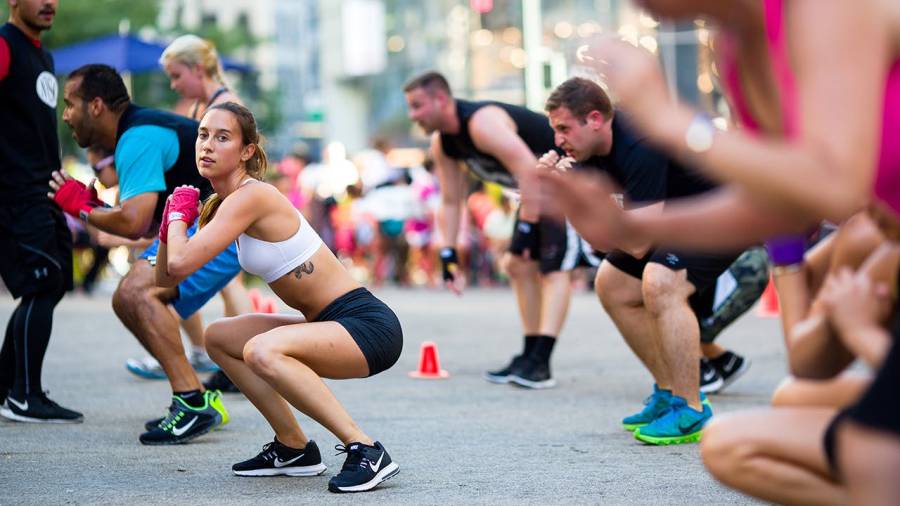 People exercise outdoors at Herald Square Plaza at a free workout class in New York City.