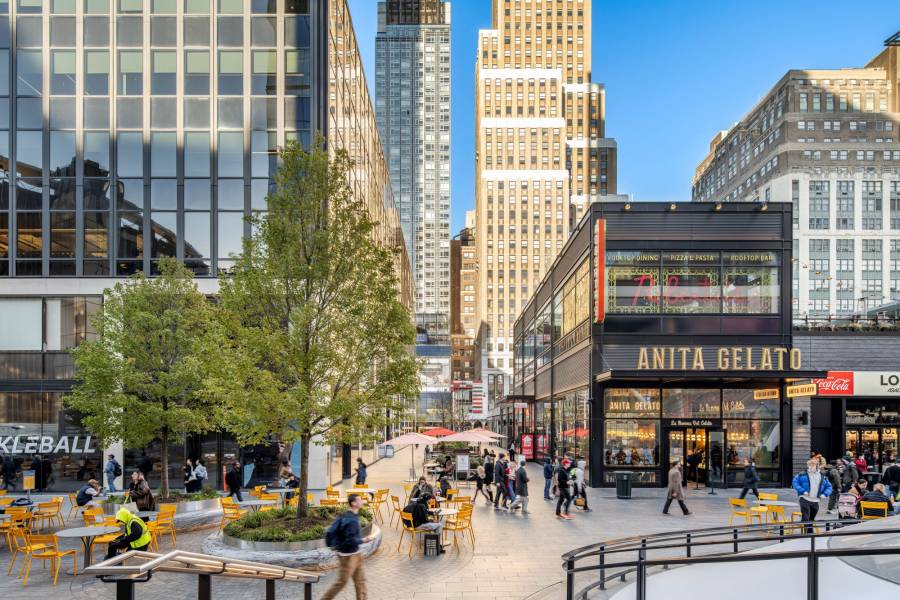 People walk through Plaza33 in New York City.