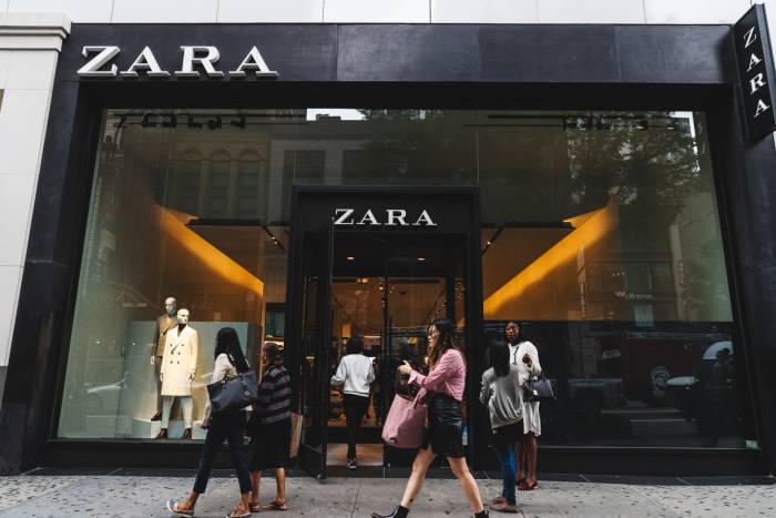 Shoppers walk and mingle in front of Zara on 34th Street in New York City.